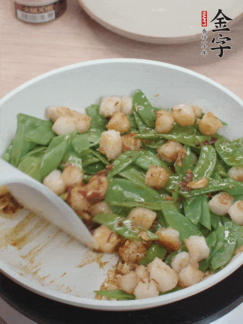 下甜豆莢、鮮貝輕輕翻炒均勻。