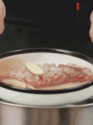 置于盤中，加冰糖100g、黃酒100g、水200g，上鍋蒸20分鐘。
